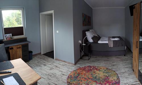 a small room with a bed and a table at Schlafort in Porta Westfalica