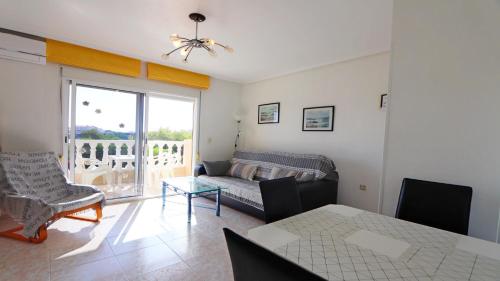 a living room with a couch and a table at Corinto 2428 in La Mata