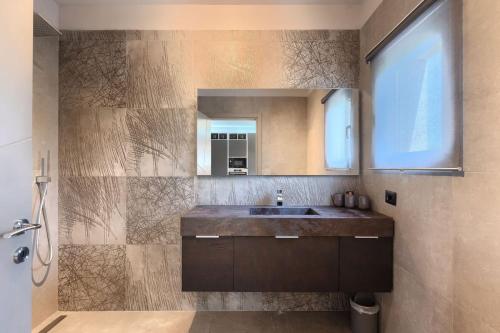 a bathroom with a sink and a mirror at Family villa Maria with pool in Vizinada in Vranje Selo