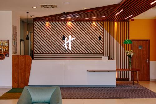 a lobby with a wall with a picture of a person on it at Holiday Inn Belgrade, an IHG Hotel in Belgrade
