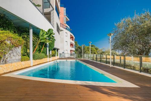 une piscine devant un immeuble dans l'établissement Luxueux appartement - Vue mer - Parking - AZ, à Beausoleil