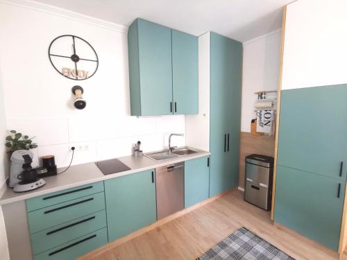 a kitchen with blue cabinets and a sink at Der schönste Platz in der Altstadt in Amberg
