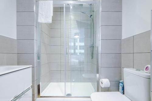 a bathroom with a shower and a toilet at NEW! Stylish 2-bed apartment in Manchester by 53 Degrees Property - Amazing location, Ideal for Small Groups - Sleeps 4! in Manchester