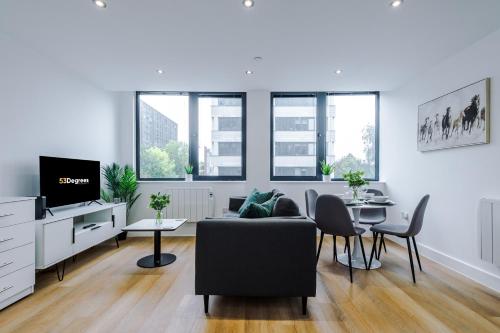 a living room with a couch and a table at NEW! Stylish 2-bed apartment in Manchester by 53 Degrees Property - Amazing location, Ideal for Small Groups - Sleeps 4! in Manchester
