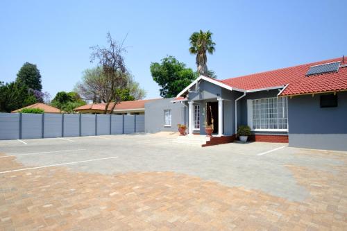 a house with a parking lot in front of it at Home Life Guesthouse in Midrand