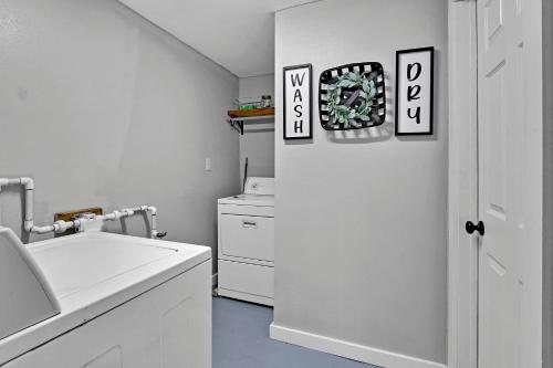 a white kitchen with a sink and a washer and dryer at Bulverde Cottage at Moonlight Getaway in Bulverde