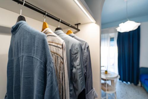 a row of shirts hanging on a rack in a room at Il Grande Blu in Terracina