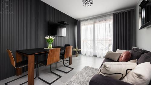 a living room with a table and a couch at City Center SPA Apartments Jaglana 6A with Parking in Gdańsk