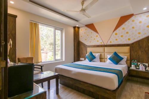 a hotel room with a bed and a television at Hotel Baba Residency - 5 Minutes from railway station in New Delhi
