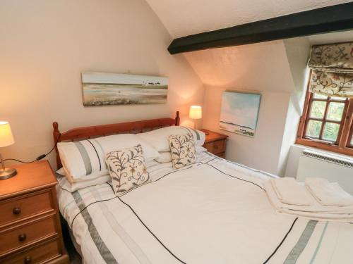 a bedroom with a large bed and a window at Holly Cottage in Whitby