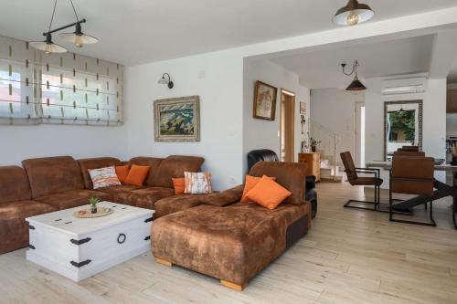 a living room with a couch and a table at Villa Alte Muhle with pool and jacuzzi in Novigrad in Novigrad Istria