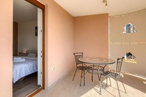 a room with a table and two chairs and a bed at Villa Alte Muhle with pool and jacuzzi in Novigrad in Novigrad Istria