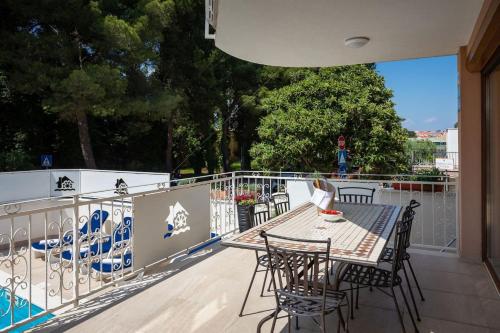 a patio with a table and chairs on a balcony at Villa Alte Muhle with pool and jacuzzi in Novigrad in Novigrad Istria