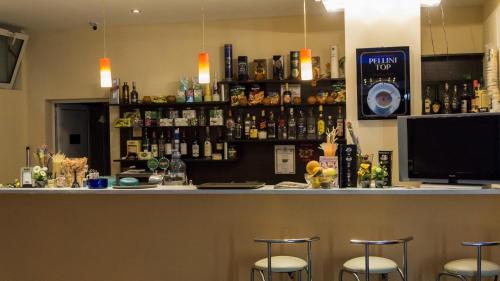 a bar with bar stools in a room at Darius HSTL in Sunny Beach