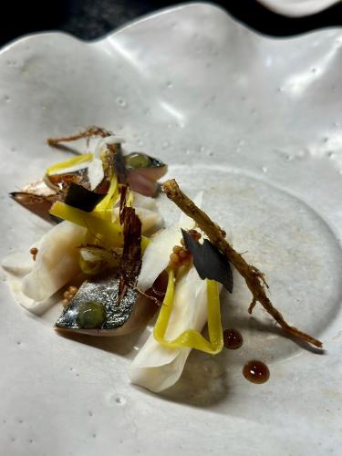 a plate of food on a white plate at Am Pfarrhof - Gourmethotel by Harald Irka in Sankt Andrä-Höch