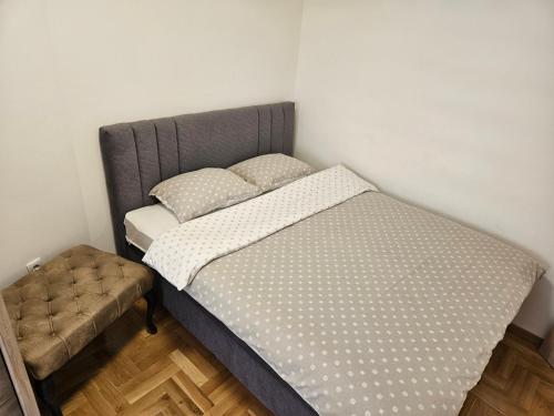 a bed in a small bedroom with a foot board at Apartman Dionis in Užice
