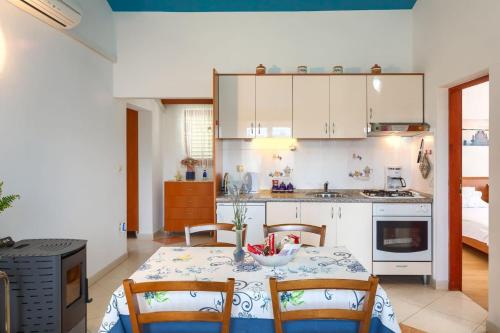 a kitchen with a table with a bowl of fruit on it at Villa Greis with 4 bedrooms and pool in Buje in Momjan