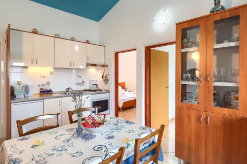 a kitchen and dining room with a table and chairs at Villa Greis with 4 bedrooms and pool in Buje in Momjan