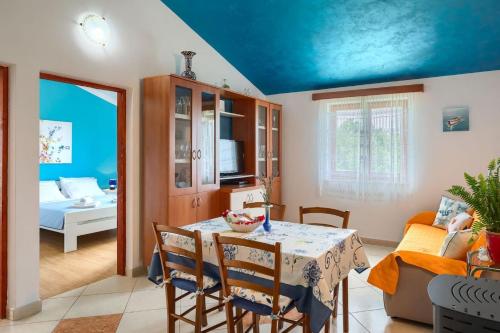 a room with a table and chairs and a living room at Villa Greis with 4 bedrooms and pool in Buje in Momjan