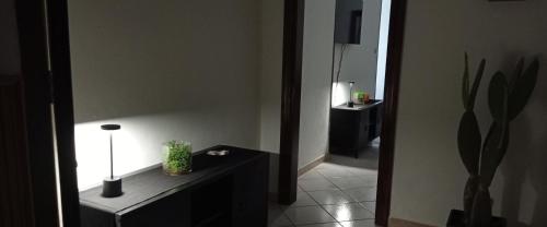 a room with a table with a lamp and a mirror at RUDIAE Palace In Lecce in Lecce