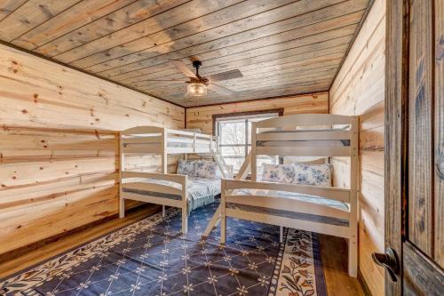 a bedroom with bunk beds in a log cabin at Coyote Creek Ranch in Martindale