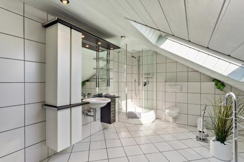 a bathroom with a sink and a shower and a toilet at Schauerte in Medebach