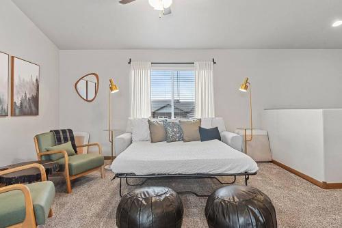 a living room with a bed and a couch at Hill's View Retreat on the Edge of the Prairie in Rapid City