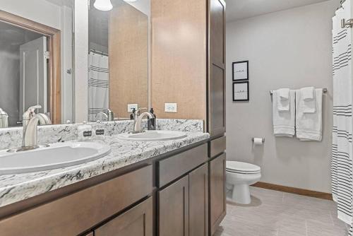 a bathroom with two sinks and a toilet at Hill's View Retreat on the Edge of the Prairie in Rapid City