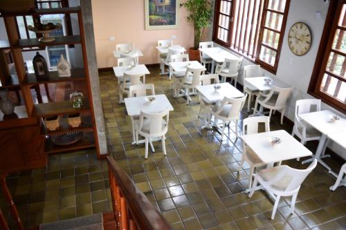 an overhead view of a restaurant with white tables and chairs at Pousada O Garimpo. in Embu