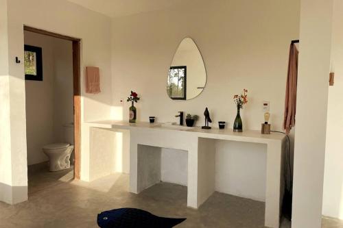 baño con encimera blanca y espejo en Sitio Lipa - Villa da Mata en São Miguel Arcanjo