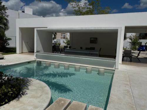 a swimming pool in front of a house at Casa Linda - Habitacion Puerto Morelos-Cancun-Playa Del Carmen in Puerto Morelos