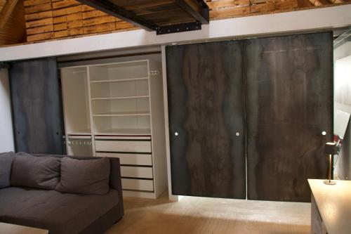 a living room with a couch and a sliding glass door at Mini-Loft in schöner Voreifel in Mechernich