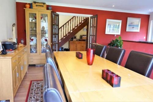a dining room with a long wooden table and chairs at Large modern house in small rural Hamlet. in Duddon