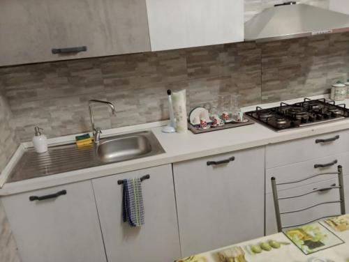 a kitchen with a sink and a stove at Tourist Rental Home ROMA in Rome