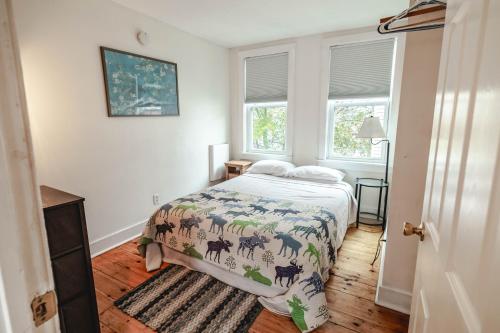 a bedroom with a bed and two windows at East end. Walk to food, beer and downtown fun. in Portland