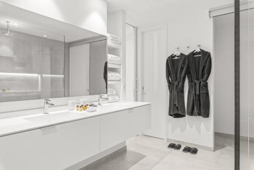 a white bathroom with a sink and a mirror at Karat Villa Zambrano in Guía de Isora