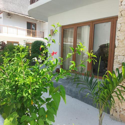 a view of a house with plants in front of it at Anna's House with pool in Pingwe