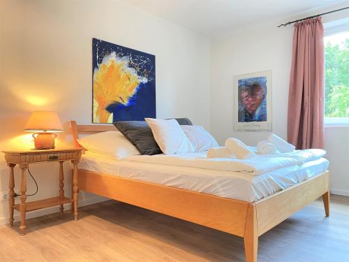 a bed in a room with a lamp on a table at One Bedroom Apartment In Groensee, Stubbenrode in Großensee