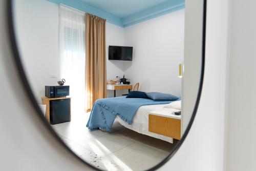 a bedroom with a bed and a mirror at Il Grande Blu in Terracina