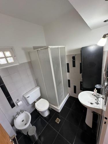 a bathroom with a toilet and a sink at Departamentos Crisol in San Fernando del Valle de Catamarca