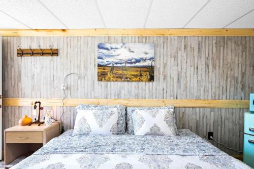 a bedroom with a bed and a wooden wall at 8 Private room in heart of Leadville dog friendly in Leadville