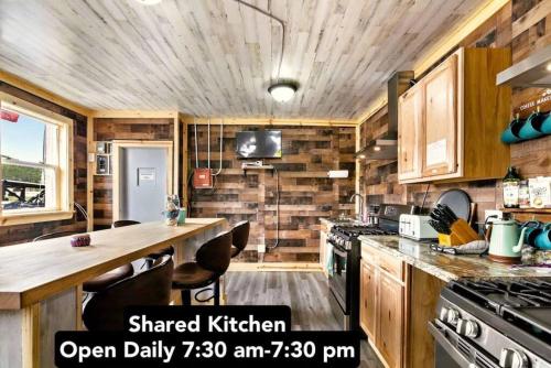 a kitchen with wooden cabinets and a counter with a stove at 8 Private room in heart of Leadville dog friendly in Leadville