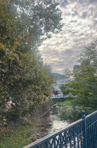 a bridge over a river next to a river at Urban River House in Florina