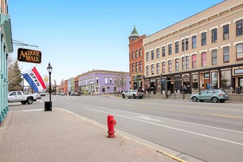 a red fire hydrant on a city street with buildings at 8 Private room in heart of Leadville dog friendly in Leadville