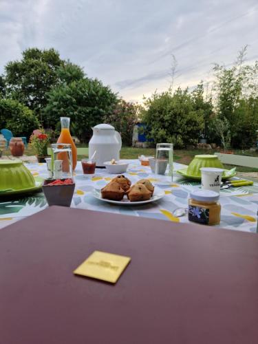 a table with a plate of food on it at Chambres d'hôtes La Frise in Corpe