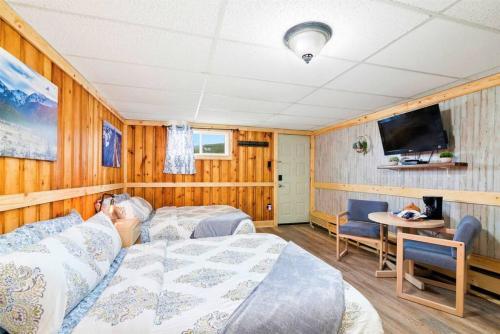 a bedroom with a bed and a tv and a table at 1 Spacious Private Room Dog Friendly Leadville in Leadville