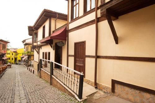 a cobblestone street next to a building with a door at Arasta Konak Boutique Hotel in Eskisehir