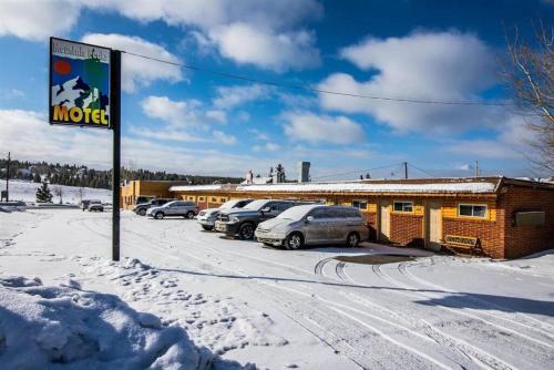 a motel with cars parked in a snow covered parking lot at 1 Spacious Private Room Dog Friendly Leadville in Leadville