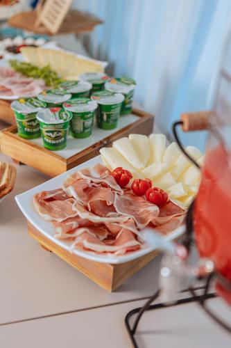 a table topped with cheese and meat and other foods at Hotel Amico in Citta' Sant'Angelo
