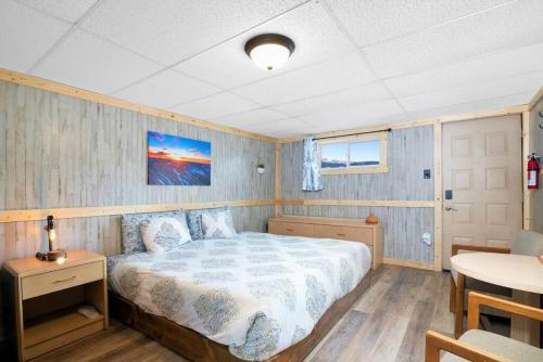 a bedroom with a bed and a table in it at 2 Dog Friendly Private Cozy Room in Leadville in Leadville